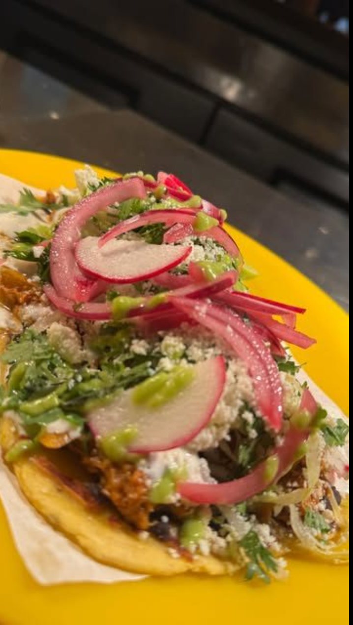Huarache topped with cilantro, pickled onion, and queso fresco