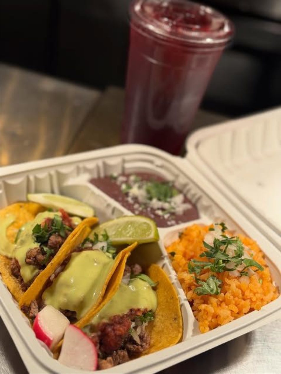 Street taco plate with rice, beans, and an agua fresca from Tacos Los Gordos